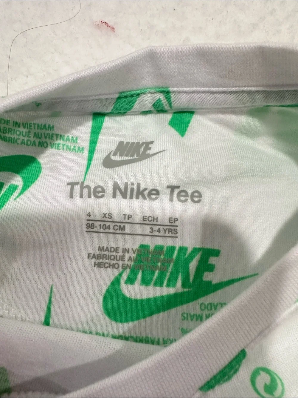 Boy’s Nike White Tee with Bright Green Allover Logo Print